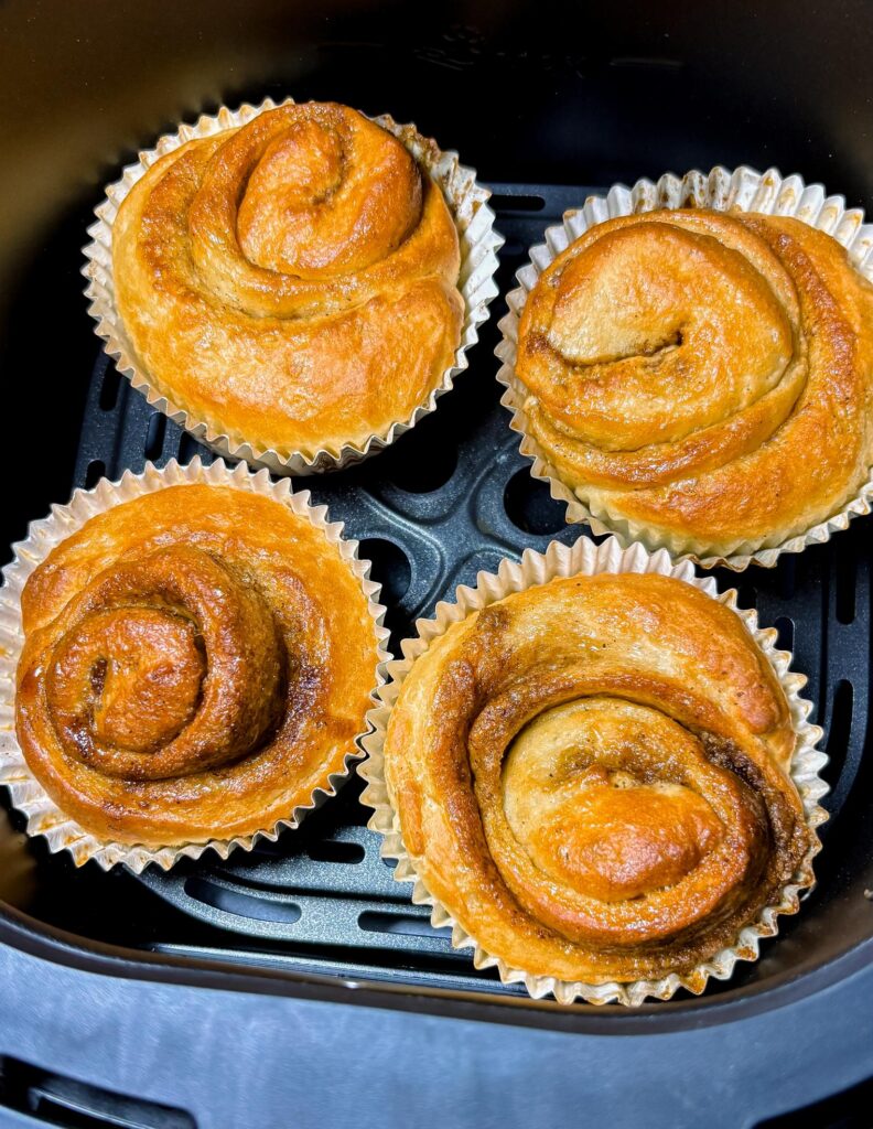 Air fryer-baked, golden brown cinnamon rolls.